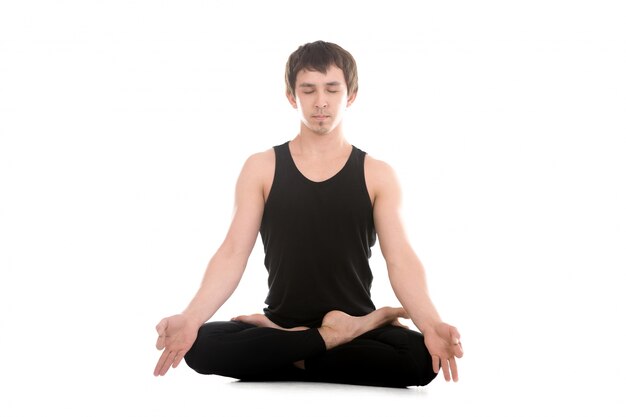 Young man in sportswear meditating