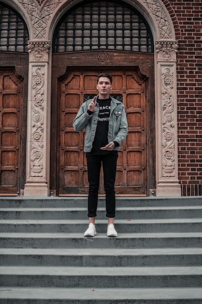 Young man on the stairs of old building