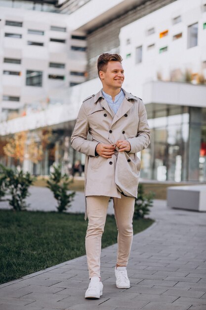 Young man standing by the business building