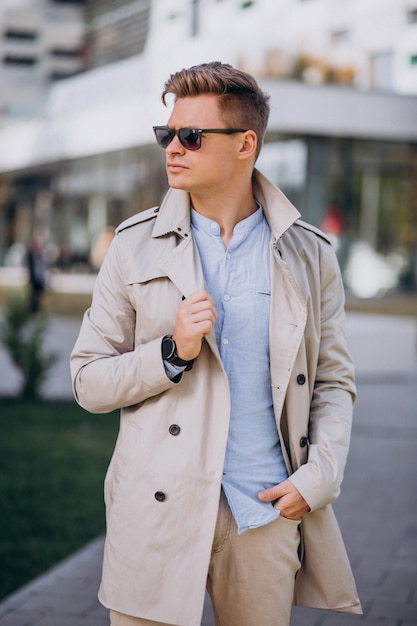 Young man standing by the business building