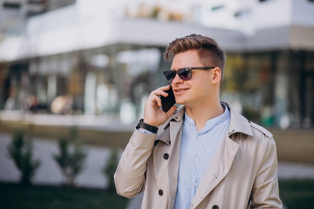 Young man standing by the business building