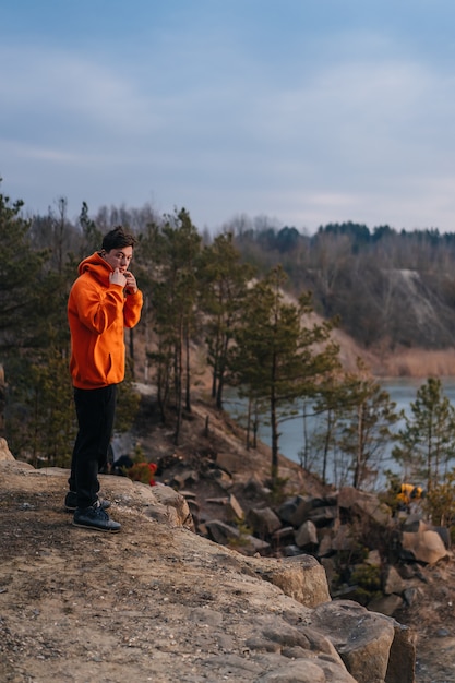 A young man standing on the edge of a cliff 