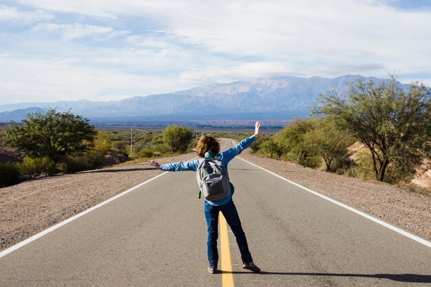 Young man standing on the highway