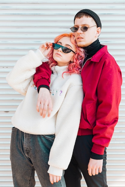 Young man standing and hugging woman 