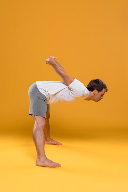 Young man stretching in yoga position