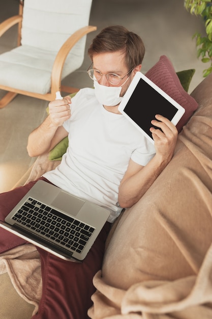 Young man studying at home during online courses for disinfector