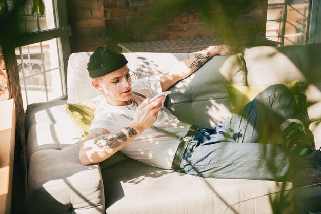 Free Photo young man studying at home during online courses or free information by hisself