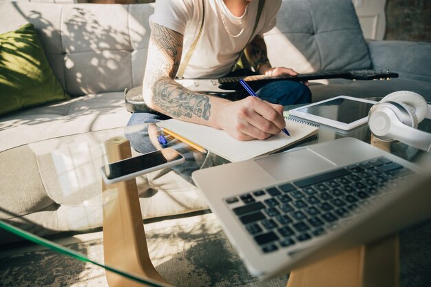 Young man studying at home during online courses or free information by hisself