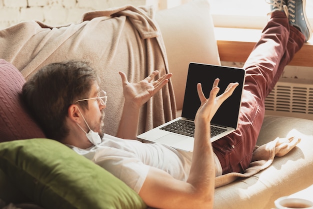 Young man studying at home during online courses for journalist, critics, writers.