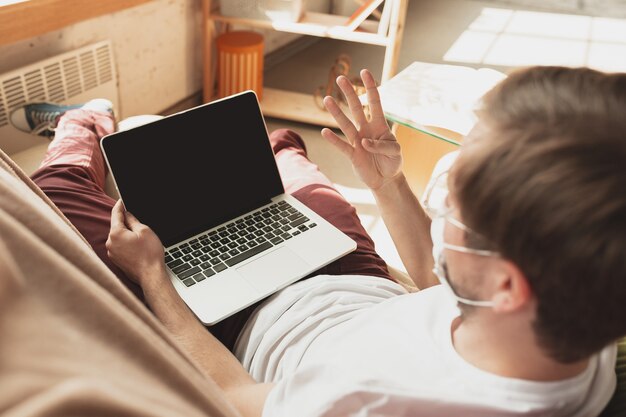 Young man studying at home during online courses