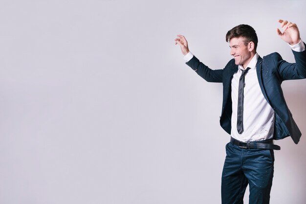 Young man in suit dancing