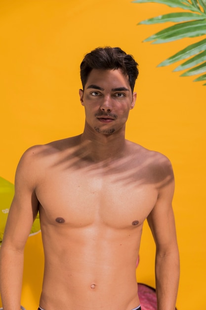 Free photo young man in swimwear on beach