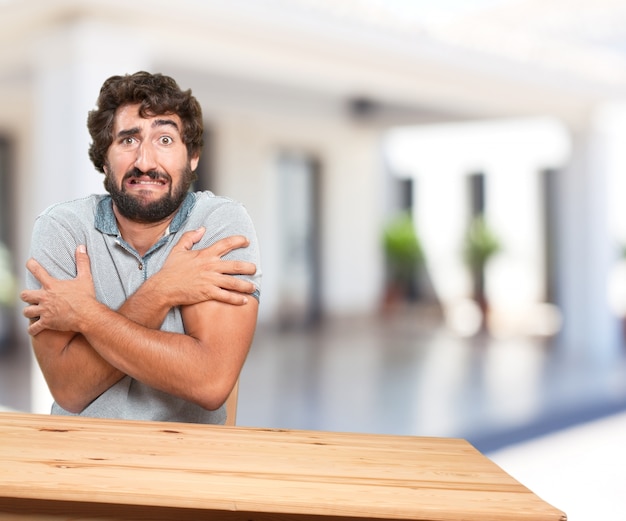 young man on a table. worried expression