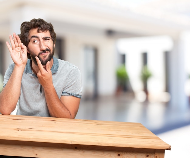 young man on a table. worried expression