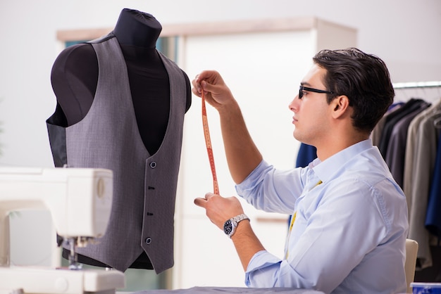 Premium Photo | Young tailor working on new clothing design