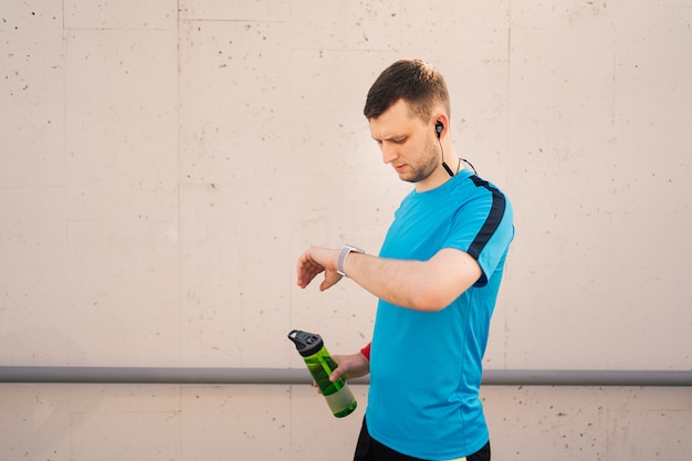 Young man taking a break - fitness concept in the city.