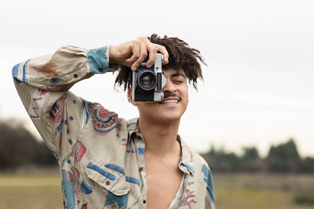 Young man taking photo while going out in the city