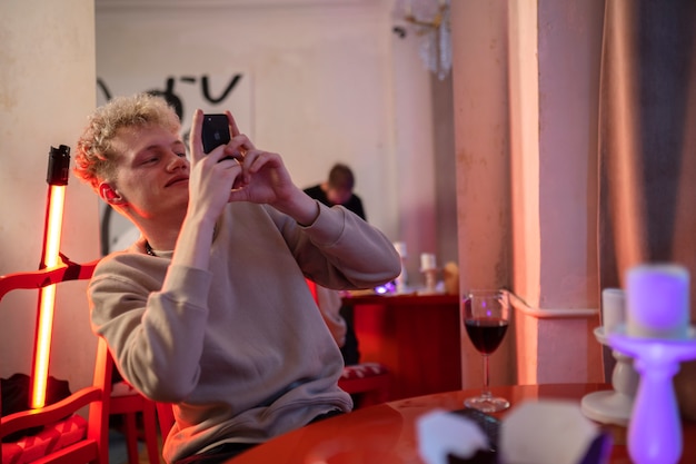 Young man taking photo with his smartphone