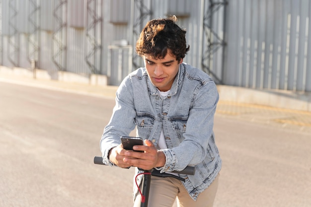 Young man taking a ride with a scooter