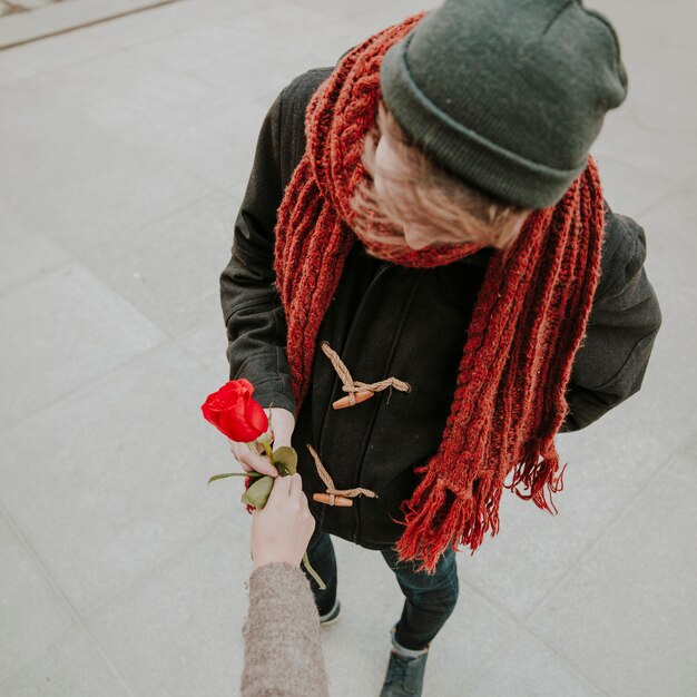 Young man taking rose