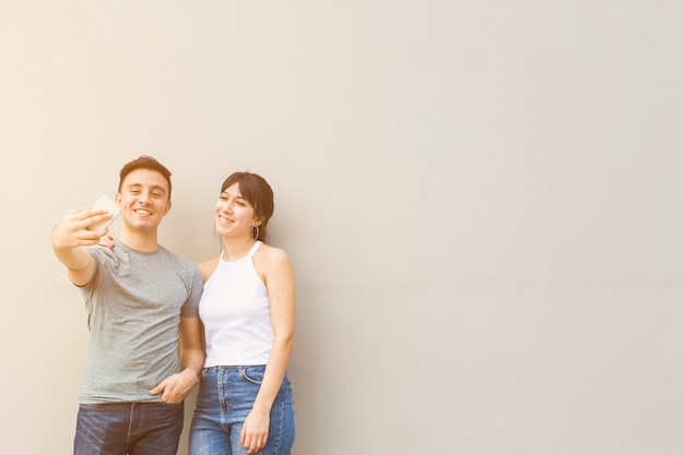 Free photo young man taking a selfie with woman