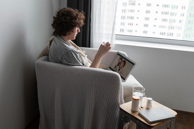 Free photo young man talking to his doctor by videocall