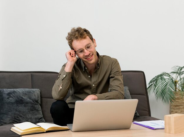 Young man talking with his coworkers in an online meeting