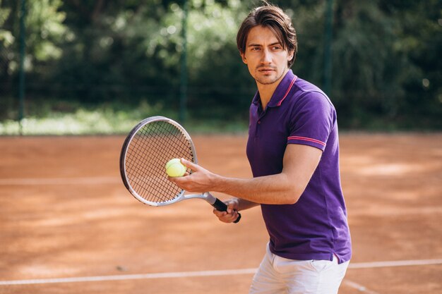 Young man tennis player at the court