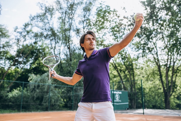 Young man tennis player at the court