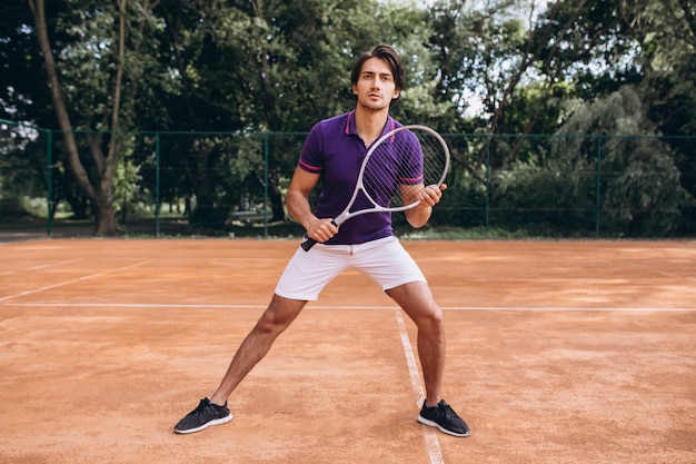 Young man tennis player at the court