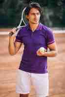 Free photo young man tennis player at the court