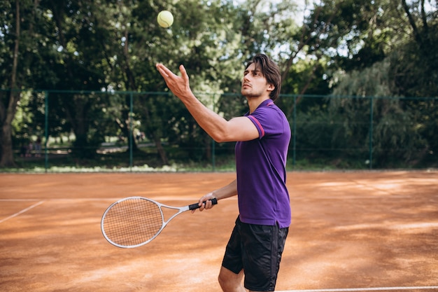 Young man tennis player at the court