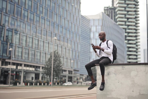 young man in th city uses a smartphone