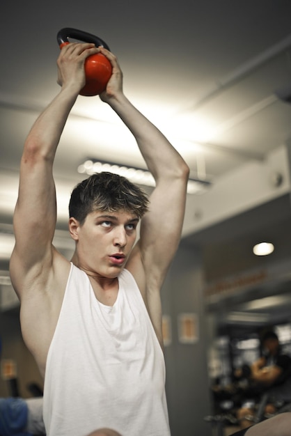 young man trains in the gym