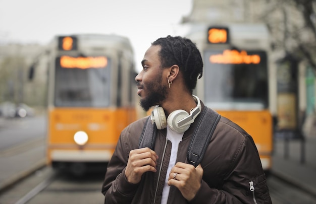 Free photo young man at a tram station