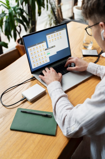 Young man typing on laptop at desk