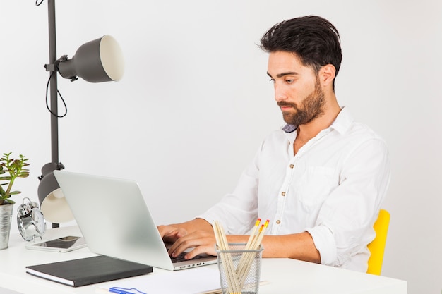 Young man typing on laptop