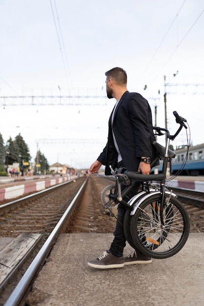 無料写真 市内で折りたたみ自転車を使用している若い男