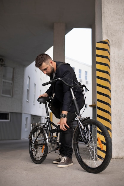 Young man using a folding bike in the city