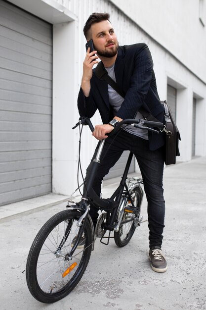 Young man using a folding bike in the city