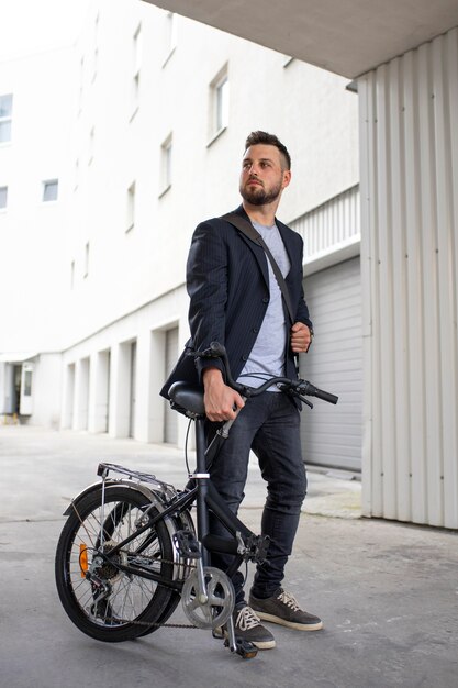 Young man using a folding bike in the city