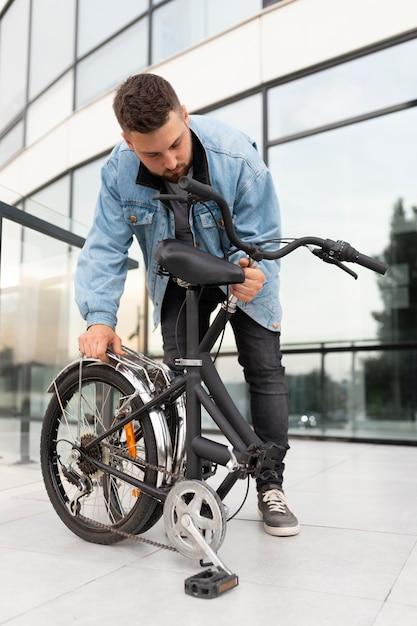 Young man using a folding bike in the city