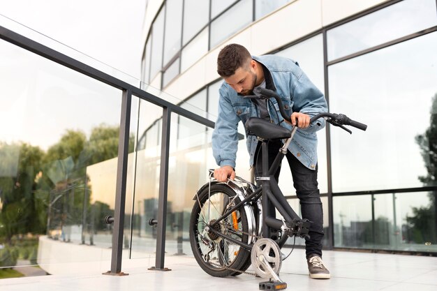 Young man using a folding bike in the city