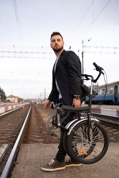 Young man using a folding bike in the city