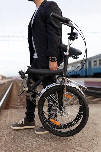 Young man using a folding bike in the city