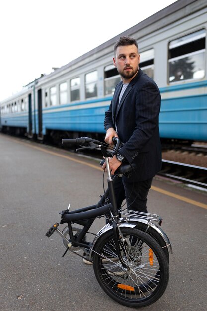 Young man using a folding bike while traveling by train