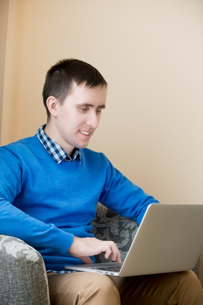 Young man using laptop indoors