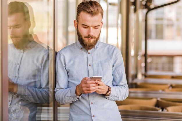 Young man using smartphone in restaurant