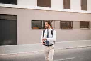 Free photo young man walking on street