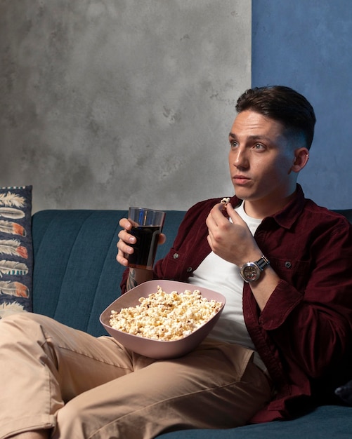 Free photo young man watching streaming service at home